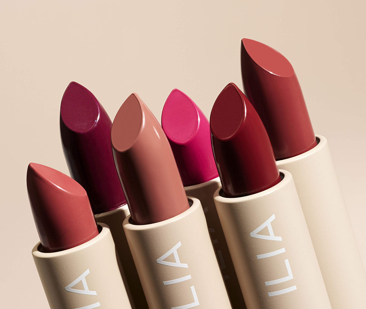 ILIA Color Block Lipstick next to coin for scale showing compact 0.14 oz size