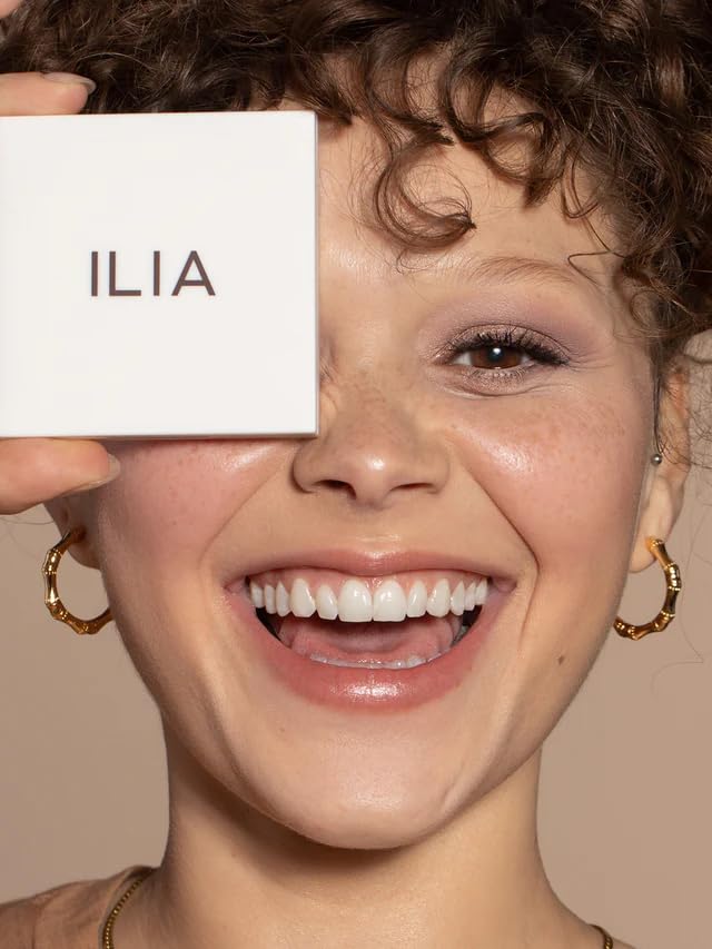 ILIA compact shown beside fingers to show size and travel friendly scale