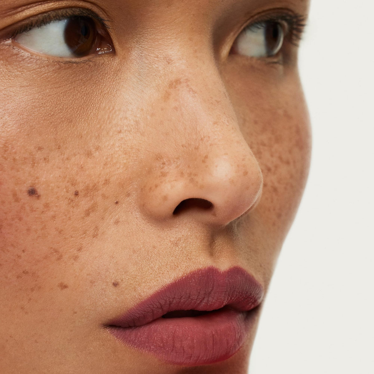ILIA lip crayon held in hand to show size and travel-friendly benefit
