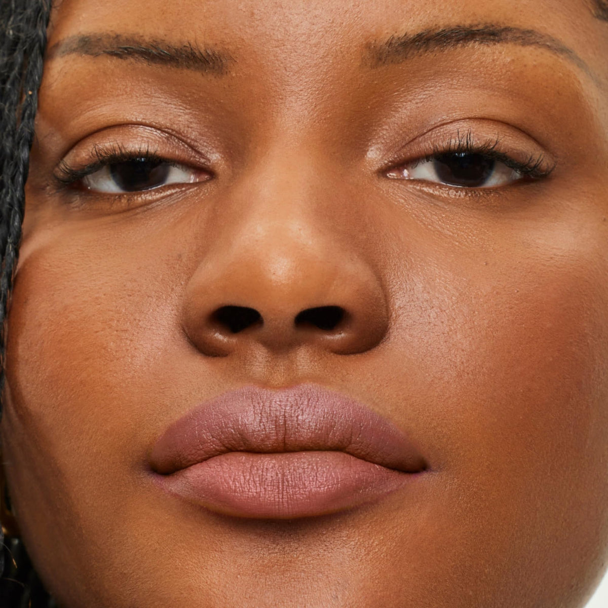 ILIA lip sketch on model neutral beige shade offering natural flattering look