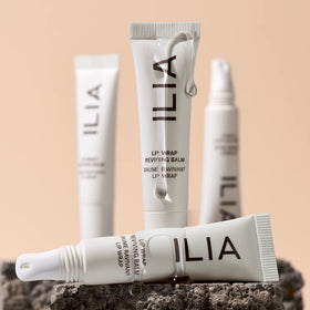 ILIA Lip Wrap held in hand to show compact 7 ml size and portability benefit