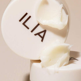 ILIA jar tucked in purse illustrating portable treatment for on-the-go care