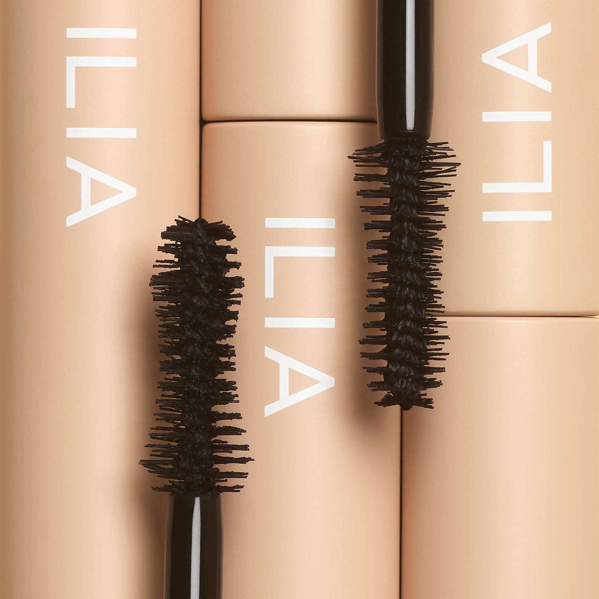 ILIA open mascara tube and cap highlighting smooth formula and applicator quality