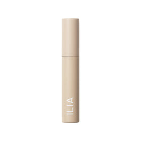 ILIA mascara packaging flat-lay with supporting clean-beauty props