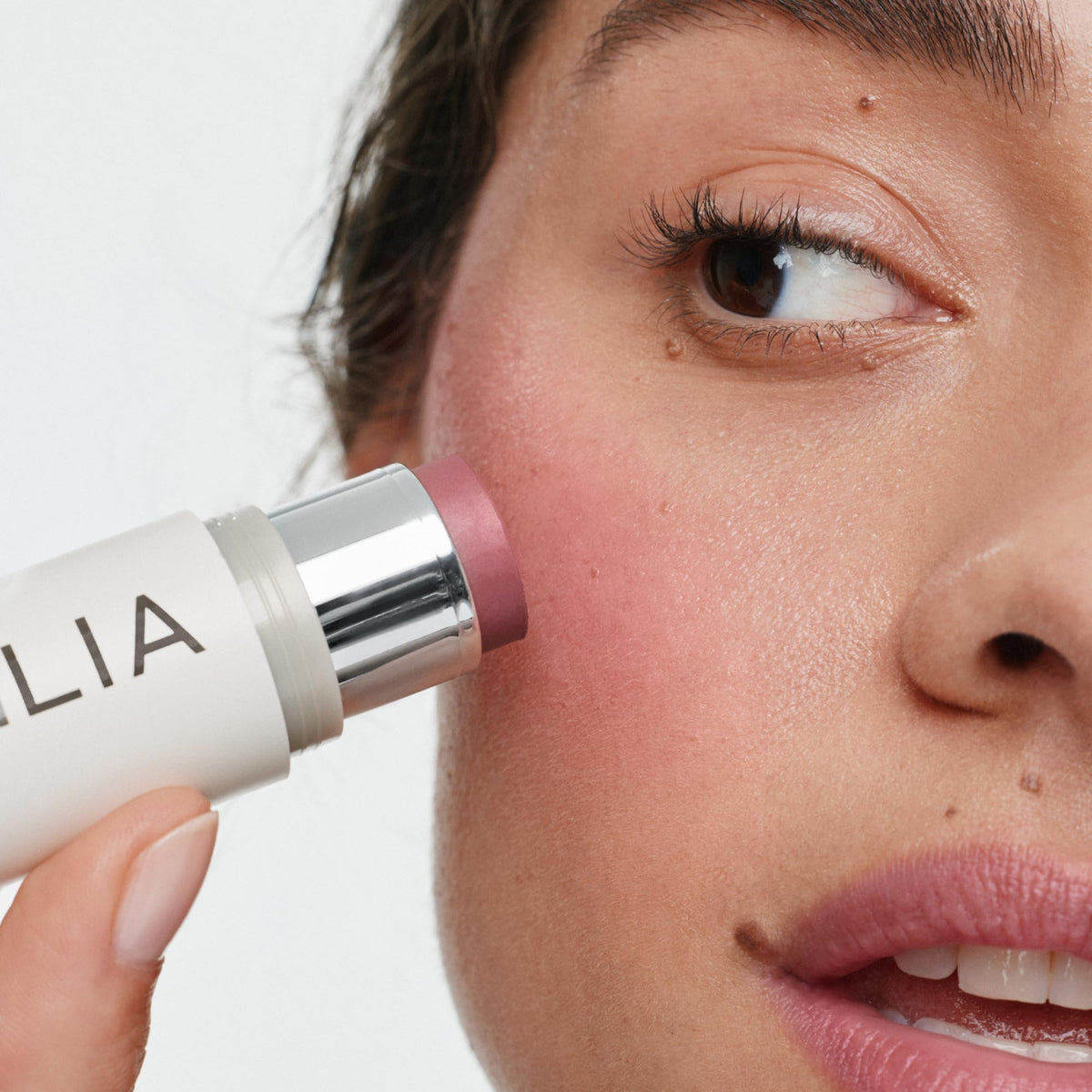ILIA multi-stick cheeks before and after demonstrating natural flushed look
