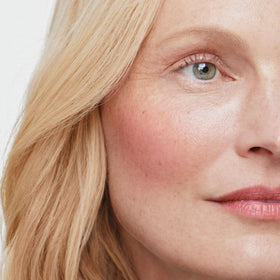 ILIA multi‑stick on lips closeup showing peach pink tint and comfortable creamy wear