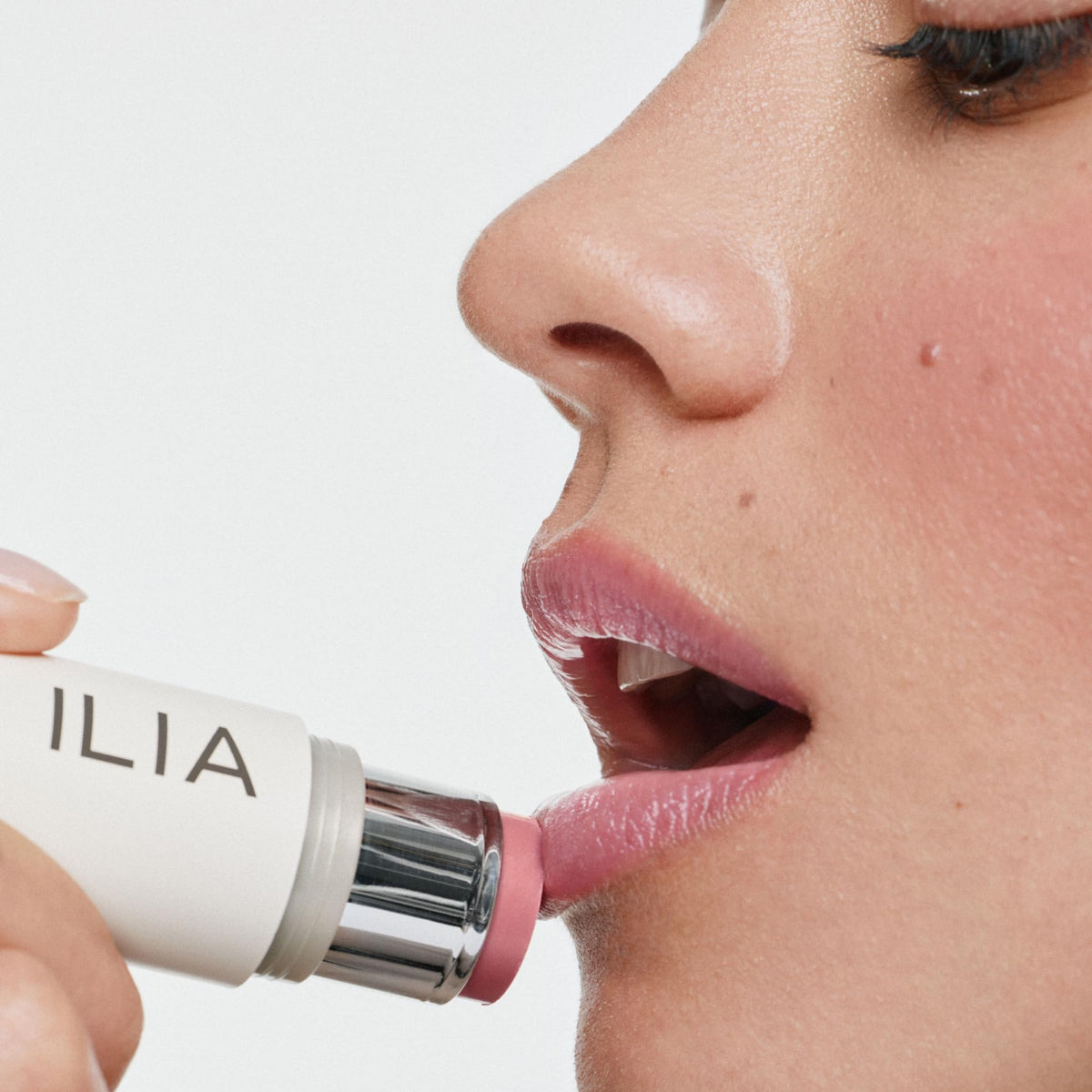 ILIA applying tenderly to cheek with finger for fresh natural flush