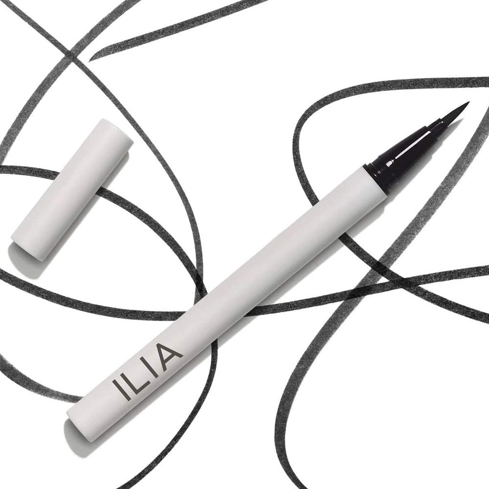 ILIA liner beside small everyday items for scale showing compact travel-friendly size