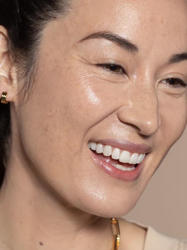 ILIA blending skin tint with a damp sponge to show buildable, seamless coverage