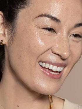 ILIA blending skin tint with a damp sponge to show buildable, seamless coverage