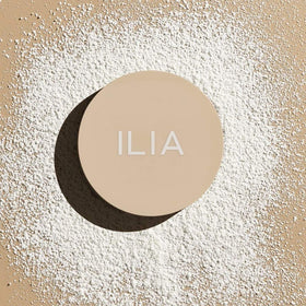 ILIA powder displayed with aloe and rosemary to highlight botanical conditioning and oil control