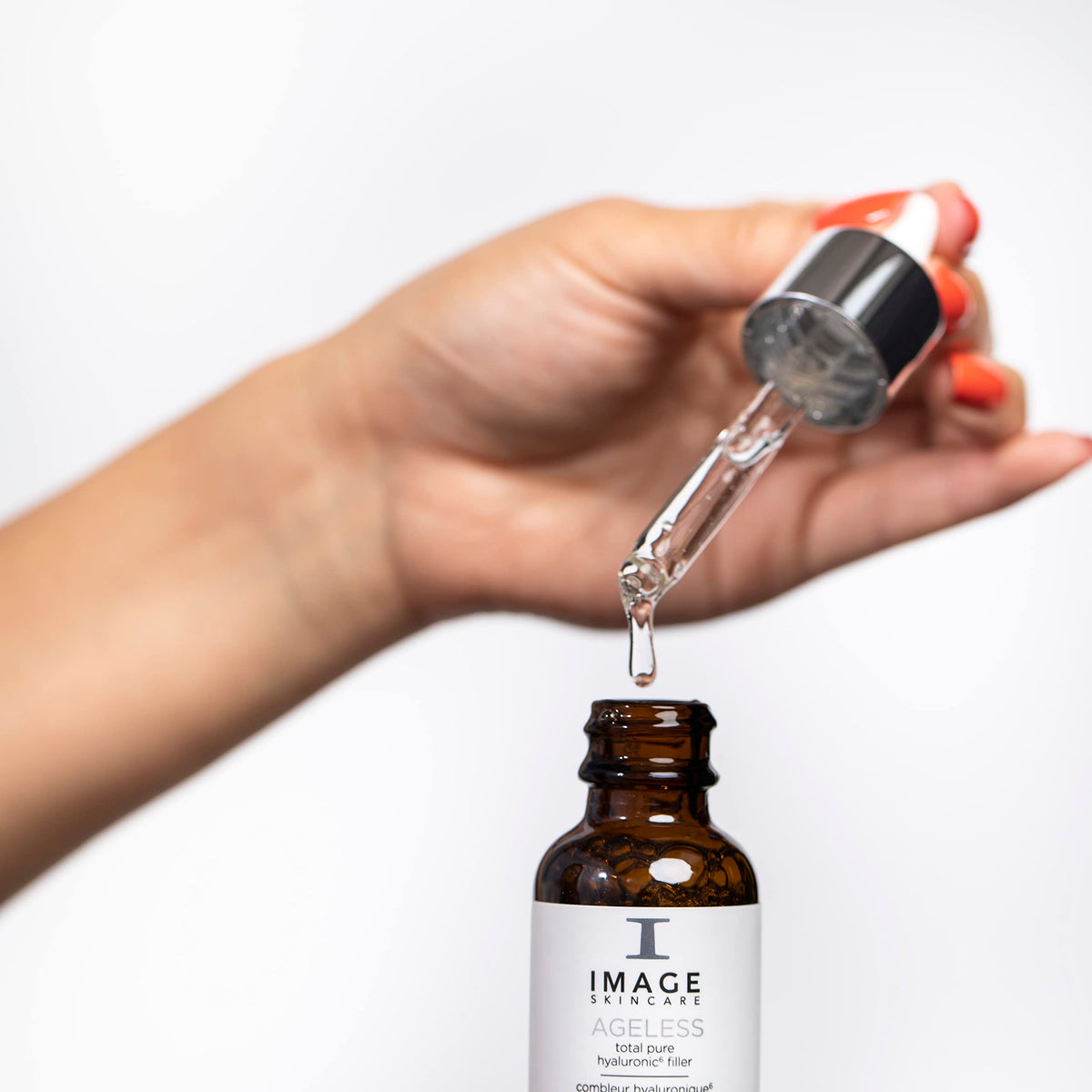 IMAGE Skincare pump dispenser close-up demonstrating hygienic precise dosing