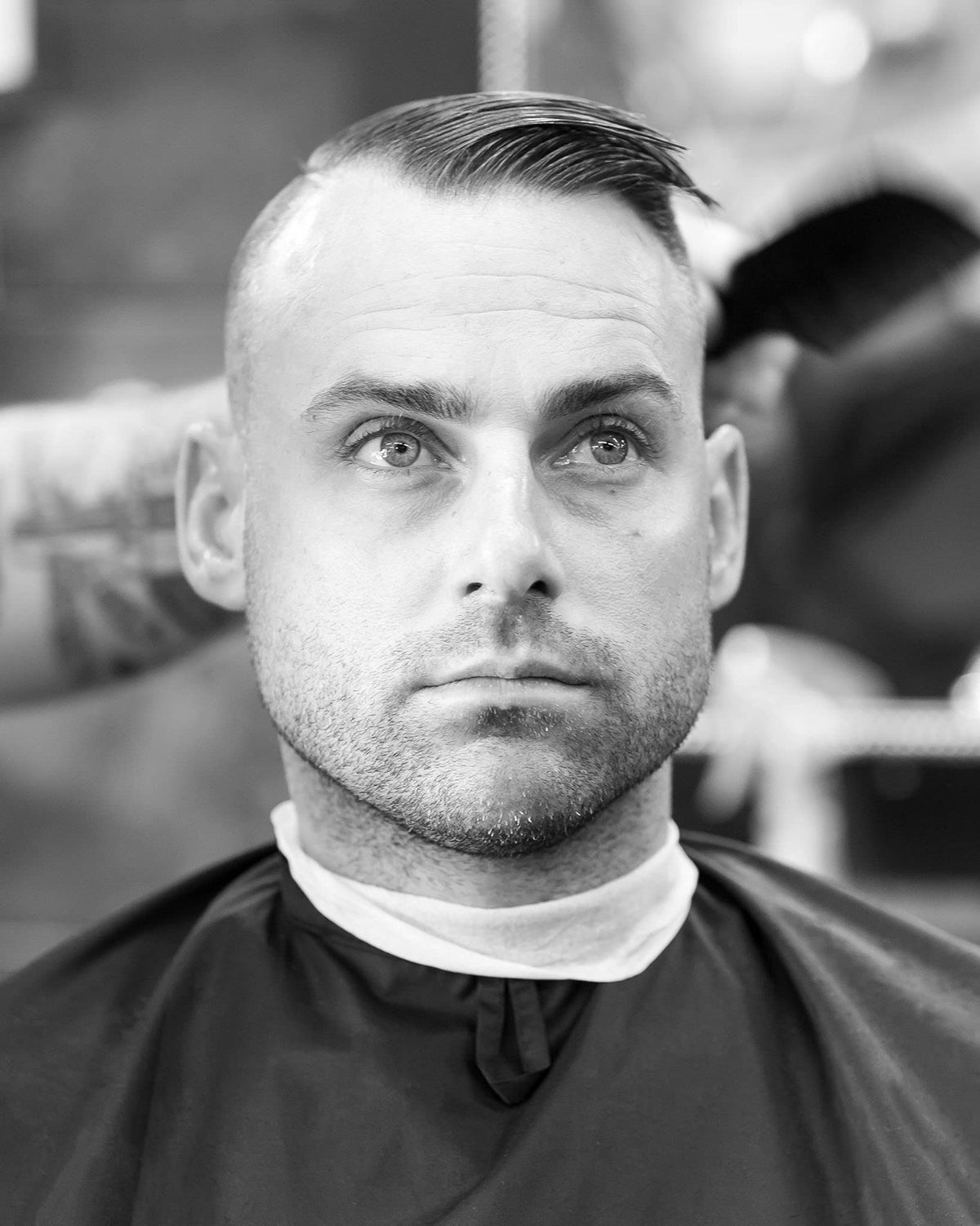 Imperial Barber matte paste being applied from hand to hair for easy styling