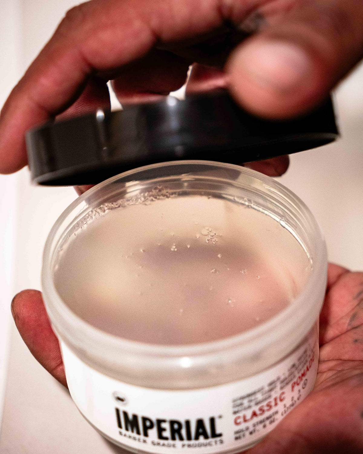 Imperial Barber Grade Products jar held in hand for scale and portability benefit