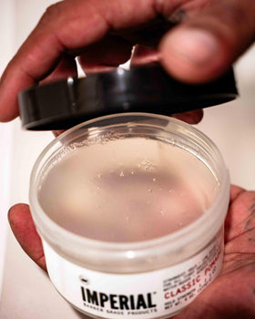 Imperial Barber Grade Products jar held in hand for scale and portability benefit
