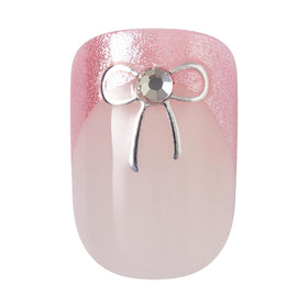imPRESS nail held next to thumb for scale, shows short squoval fit