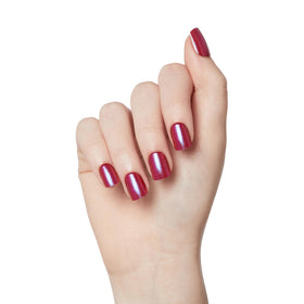 imPRESS hand holding a press-on nail to show scale and instant salon look benefit