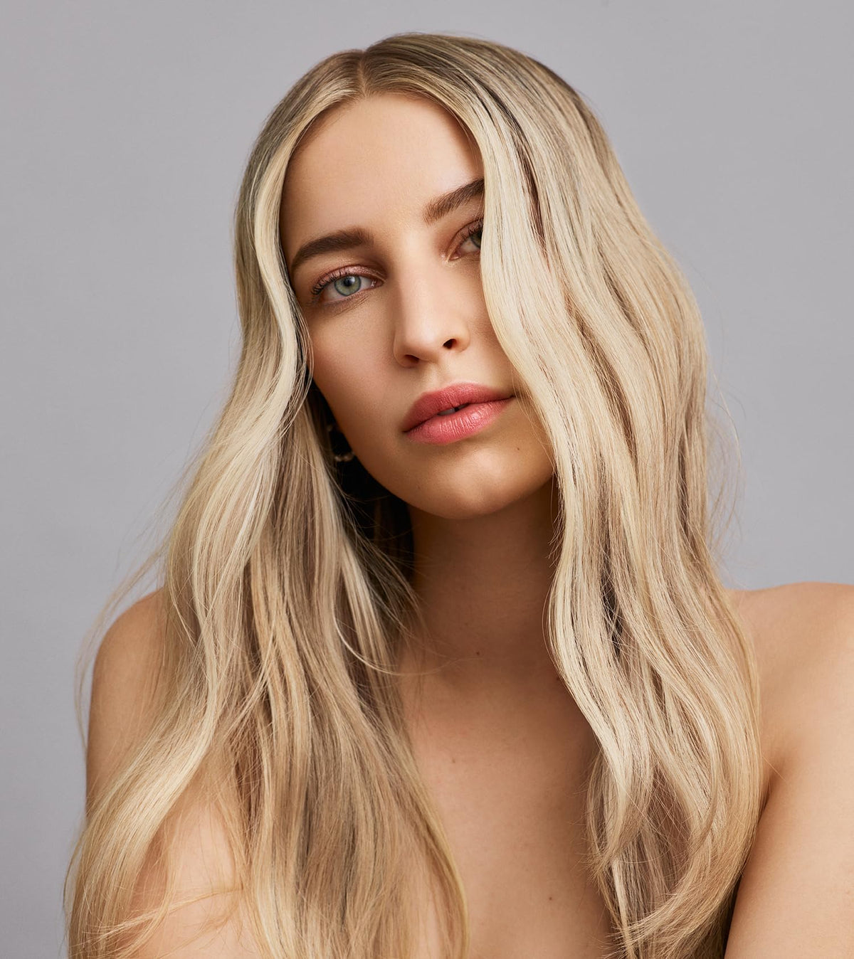 IN COMMON lifestyle shot at the beach showing heat and UV protection on styled hair