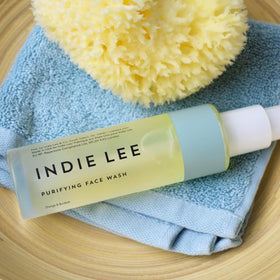 Indie Lee bottle cap and pump detail showing easy dispense and controlled use