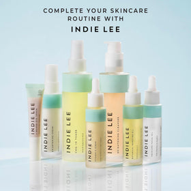 Indie Lee toner being applied to a cotton pad for gentle toner application and pore clarity