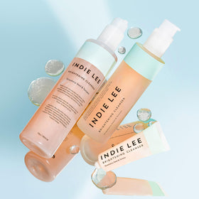 Indie Lee ingredient display with sunflower and tomato extracts highlighting antioxidants
