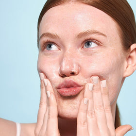 Indie Lee mask application on damp skin showing gentle exfoliation benefits
