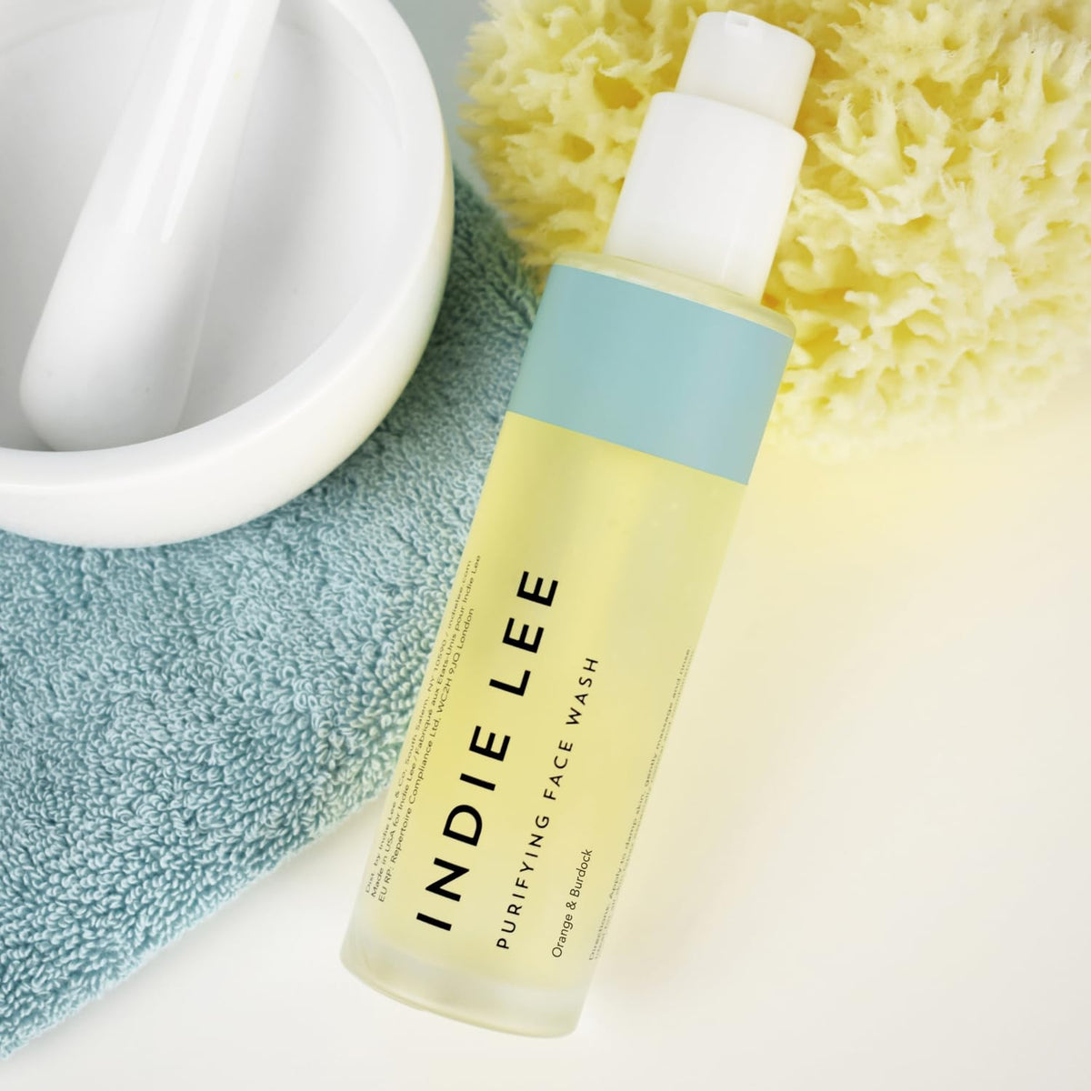 Indie Lee wash in hand lather demonstration showing removal of makeup and oil