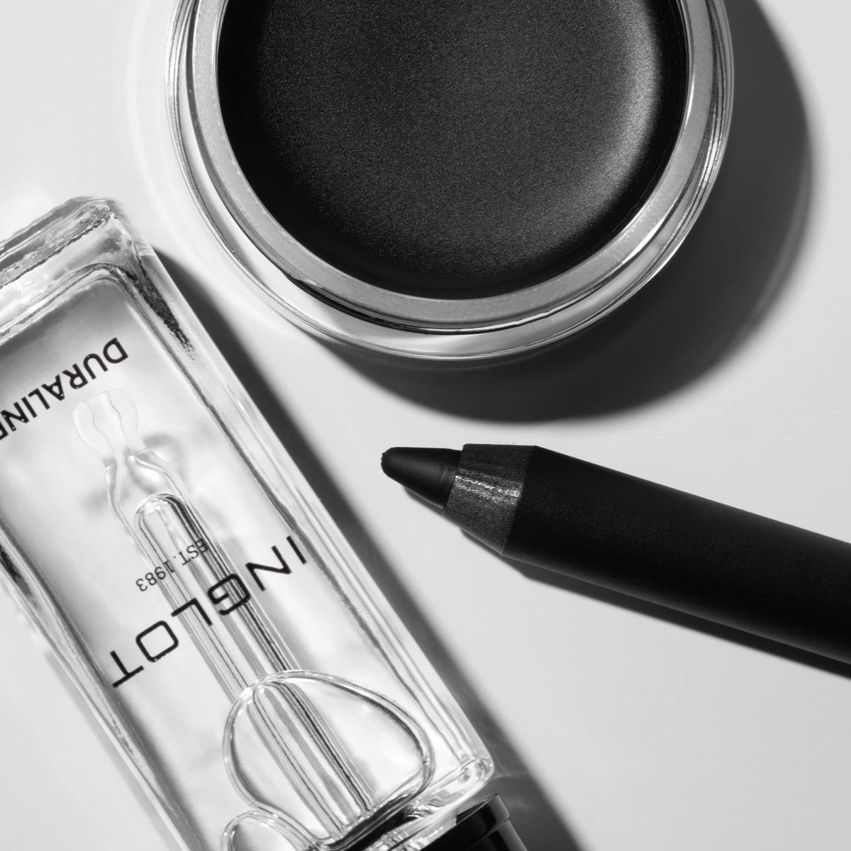Pot beside a coin for scale showing Inglot compact travel-ready convenience