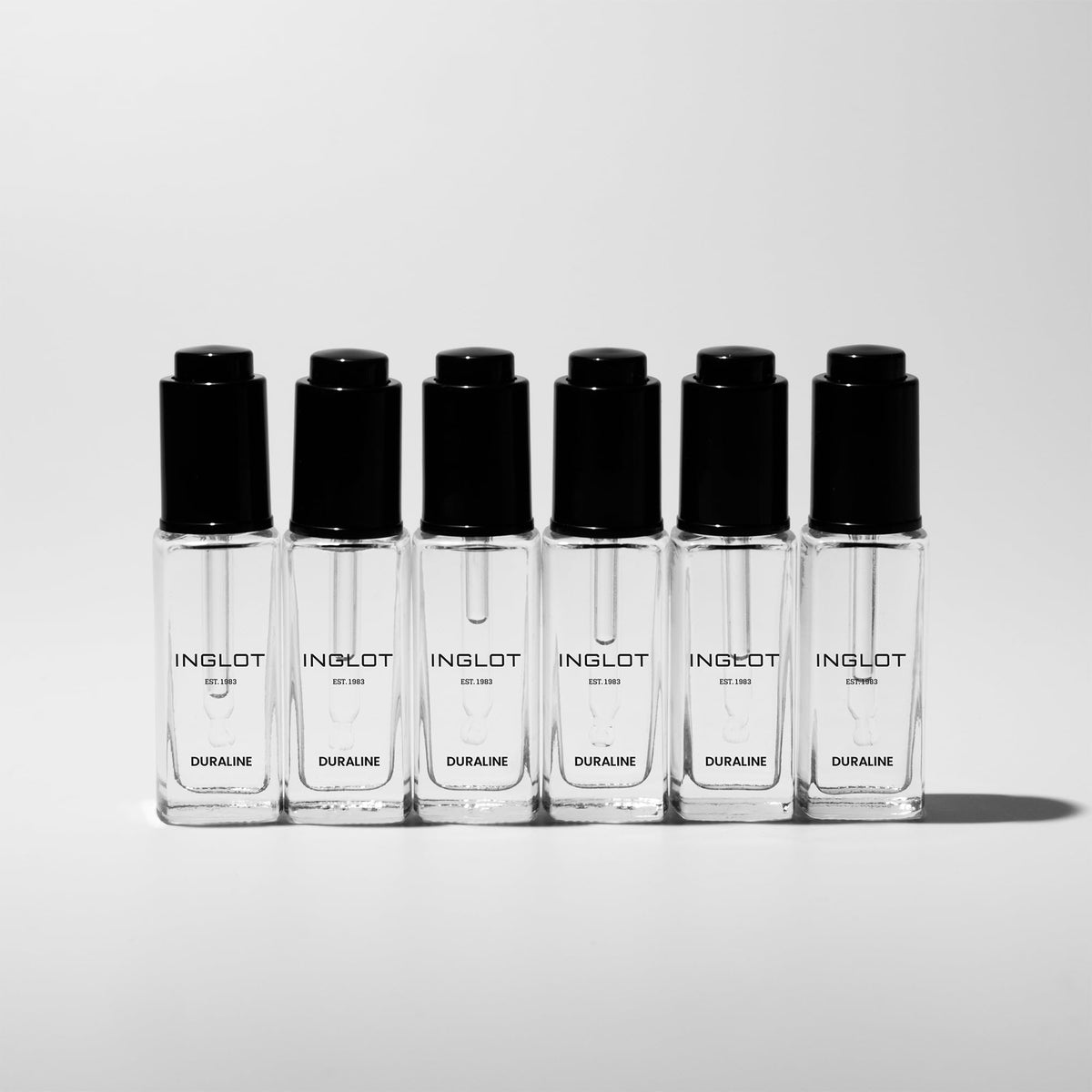 Inglot Duraline clear texture close-up demonstrating smooth shine and bonding action
