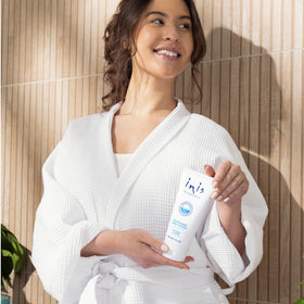 Inis being applied to skin illustrating fast absorption and non-greasy feel