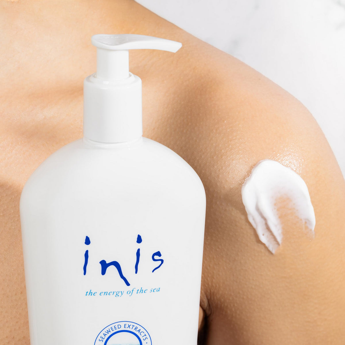 Inis lotion texture on palm, showing creamy non-greasy feel benefit