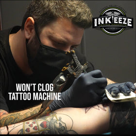 Person holding 3.3oz INK-EEZE tube showing portable professional aftercare