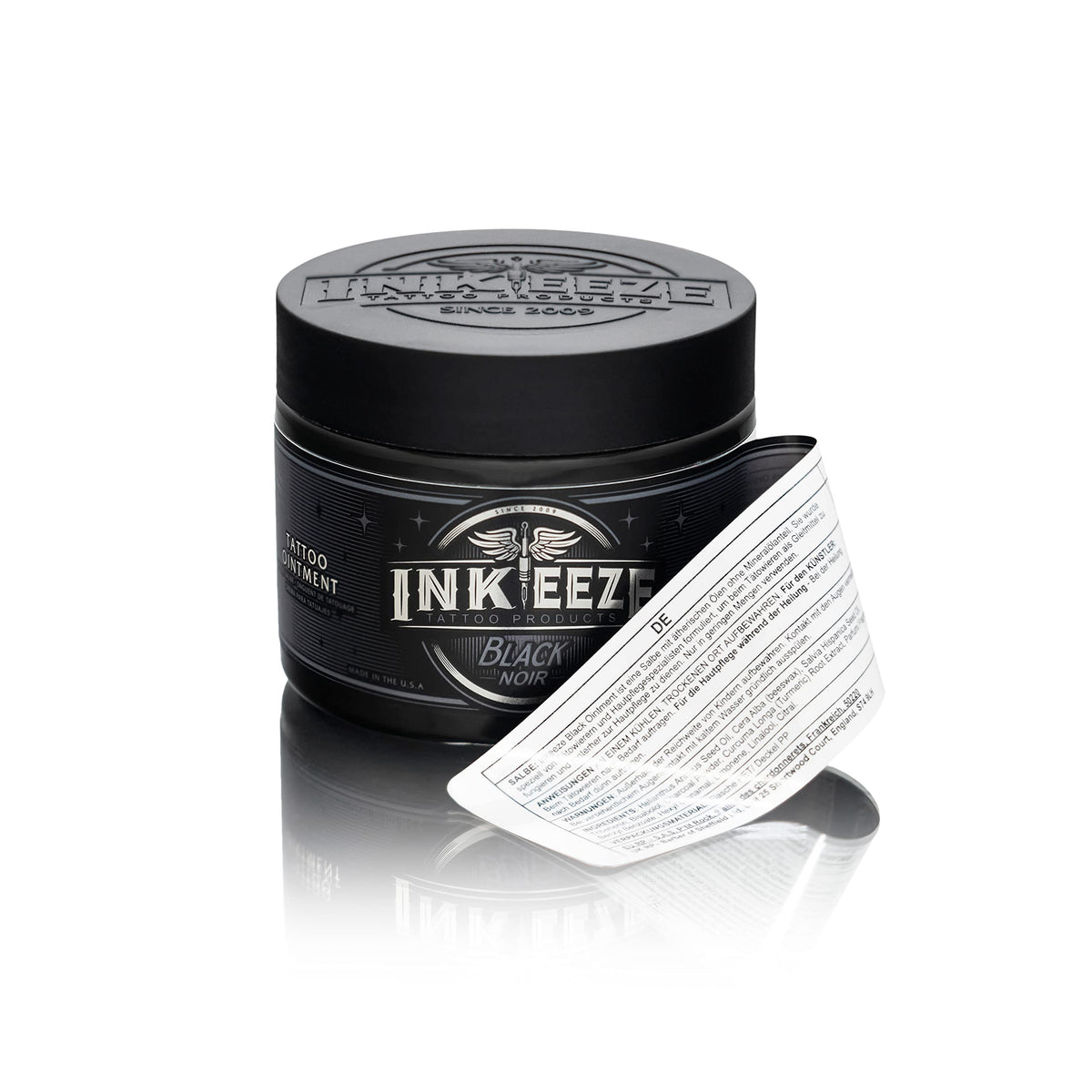 INK-EEZE ingredient display with chia seed oil and beeswax highlighting natural oils