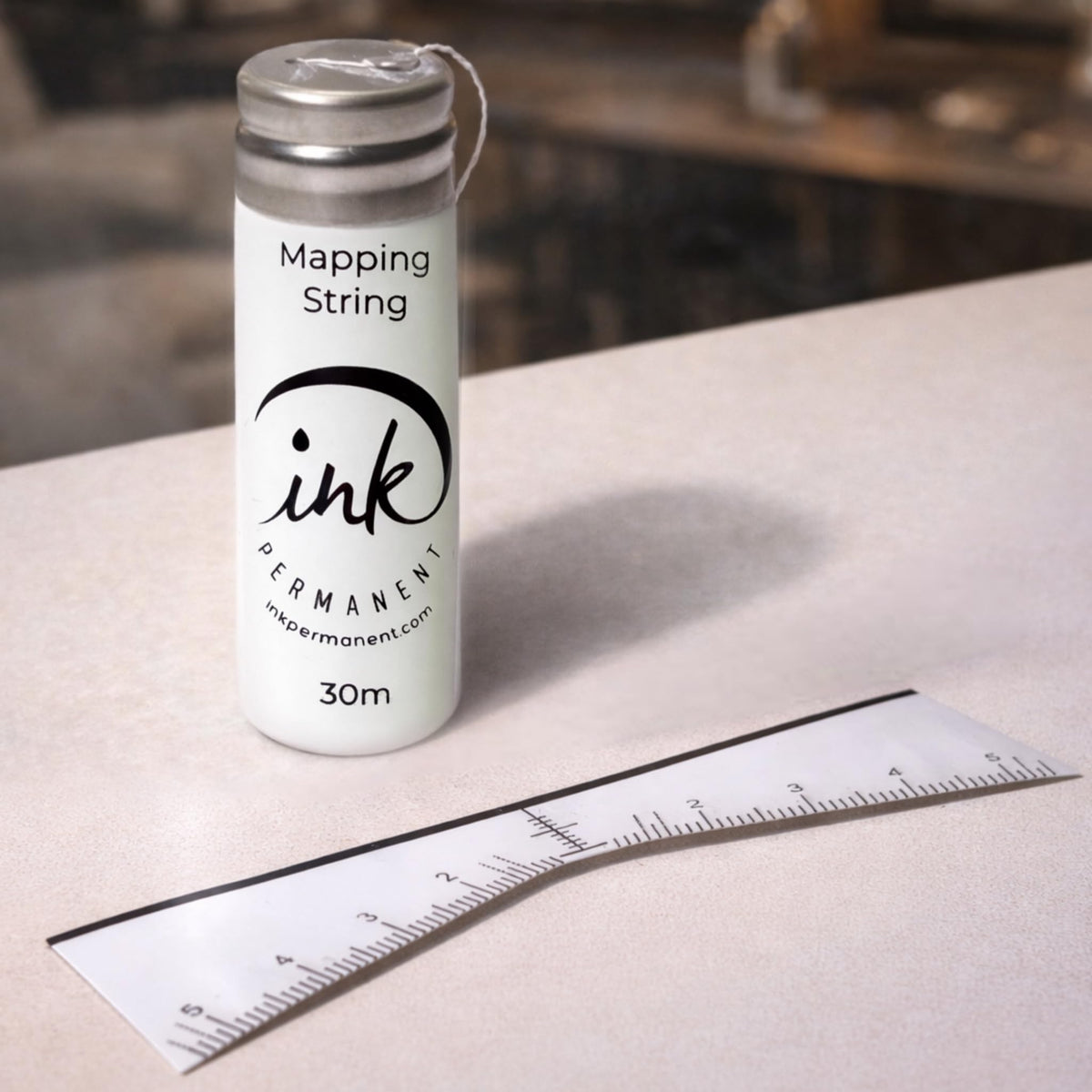 Ink Permanent close-up of pre-inked string showing clear guide line for faster alignment