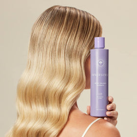 INNERSENSE shampoo texture on hand showing gentle purple tint