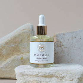 INNERSENSE bottle on bathroom shelf with plants, suggests natural, clean routine benefit