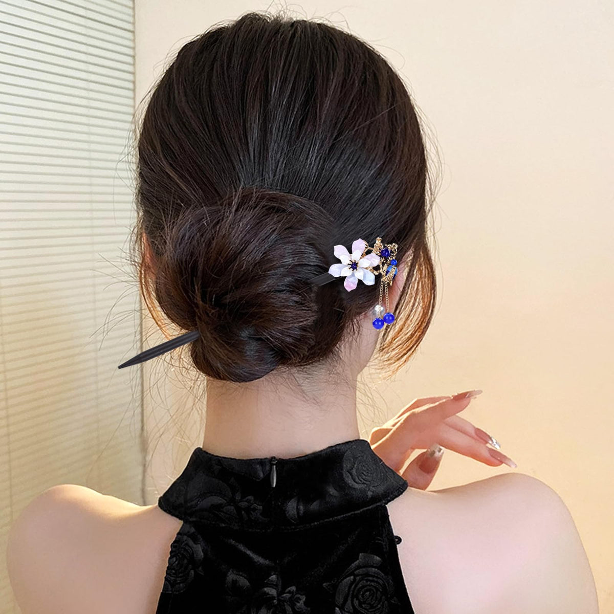 inSowni model styling a bun with hair sticks showing secure hold and elegant finish