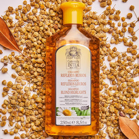 Intea bottle beside chamomile flowers emphasizing natural extract