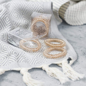 invisibobble SLIM in an evening outfit highlighting metallic finish