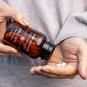 Isagenix bottle staged on bathroom shelf to suggest daily routine