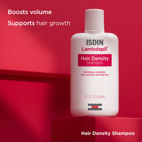 ISDIN Lambdapil shampoo pouring from bottle showing texture and spreadability