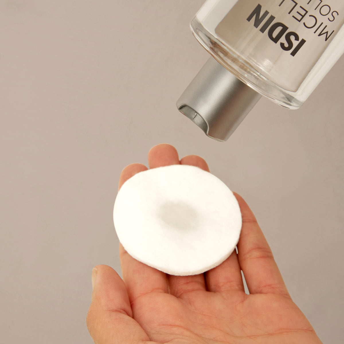 ISDIN micellar open cap with pour demonstrating easy controlled dispensing