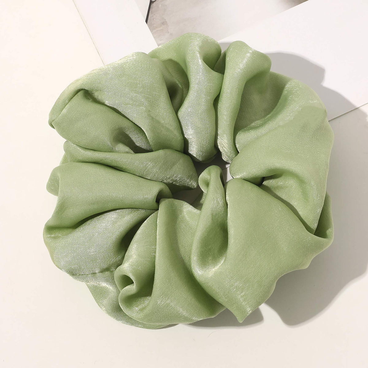 Ivyu scrunchie holding a high bun to show strong hold and decorative look