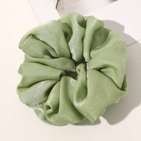 Ivyu scrunchie holding a high bun to show strong hold and decorative look