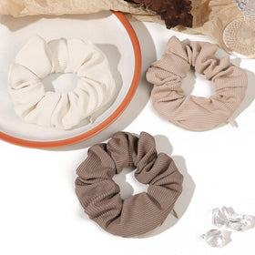 Ivyu scrunchie size compared with a coin showing compact stash capacity