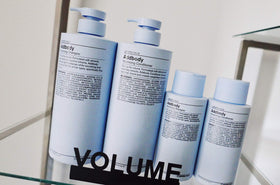 J Beverly Hills 12 oz bottle beside common items to show size and travel convenience