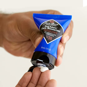 Jack Black tube beside daily routine items showing compact travel-friendly size