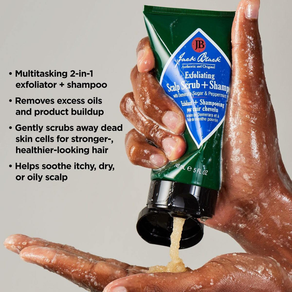 Jack Black product on fingertips massaging scalp demonstrating soothing benefit