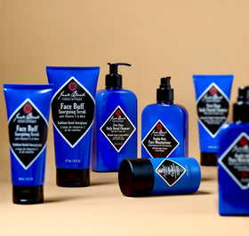 Jack Black cleansing set next to a travel bag illustrating portability and grooming-on-the-go benefit