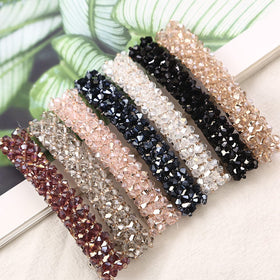 Jakeni front packaging view showing sparkling flower barrette and elegant presentation